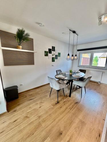 a dining room with a table and chairs at FeWo-Palmtrees 4 - Große moderne 2 Zimmerwohnung mit Süd-West Balkon in Gladbeck-Mitte Nähe Movie Park und Arena AufSchalke in Gladbeck