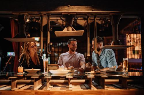 a group of people sitting at a table in a restaurant at Hilton Dubai Palm Jumeirah in Dubai