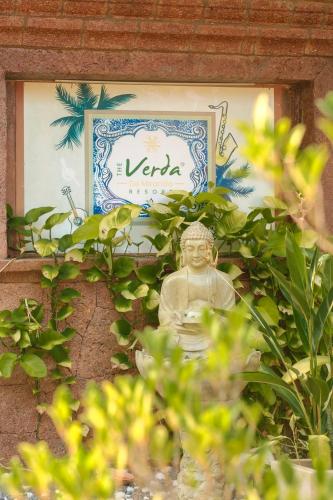 a statue of a buddha in front of a sign at The Verda De Miranda Resort Morjim North Goa in Morjim