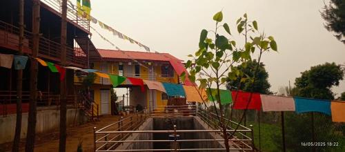a street with prayer flags in front of a building at Everest Home Stay Temal Kalimati Tower in Thapathali
