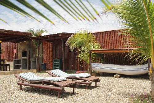 a patio with two lounge chairs and a tub at Guille Bungalows in Canoas De Punta Sal