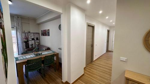 a kitchen and a dining room with a table and chairs at Albachiara Apartment vicino al mare di Capaci in Capaci