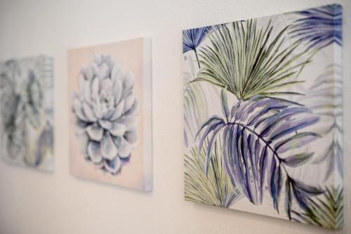 three pictures of plants on a wall at Zentrale, ruhige Wohnung auf dem Werder, 4 Personen in Magdeburg