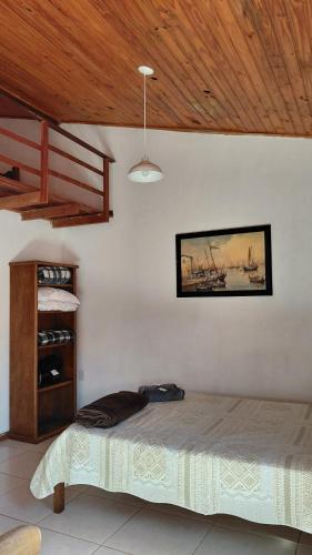 a bedroom with a bed and a painting on the wall at Vila Paolino in São Pedro da Serra