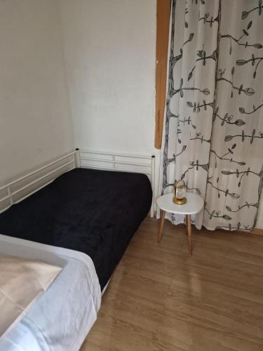 a bedroom with a bed and a table and a curtain at PM 34 Strada delle Primule in Pesaro