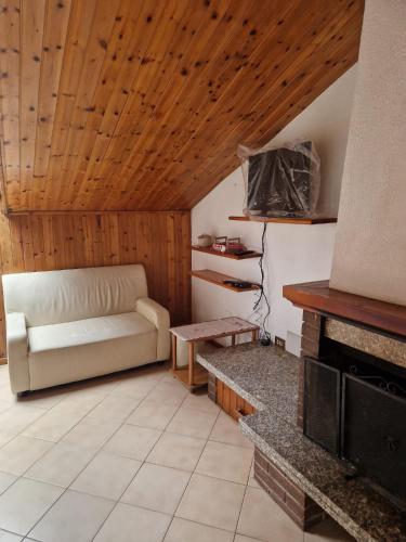 a living room with a couch and a fireplace at PM 34 Strada delle Primule in Pesaro