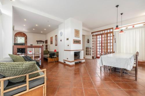 a living room with a table and a fireplace at Villa Rossana sul mare in Santa Flavia