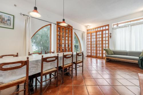 a dining room with a long table and chairs at Villa Rossana sul mare in Santa Flavia
