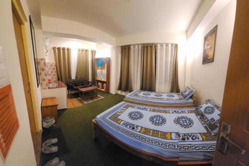 a bedroom with a bed and a living room at Dolma's Homestay in Phensāng
