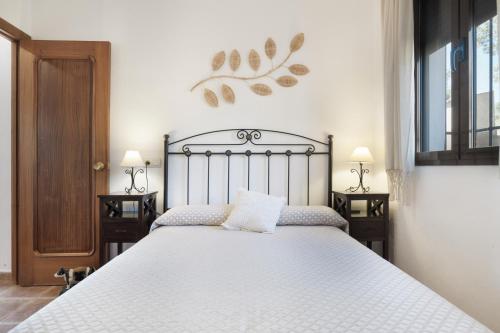 a bedroom with a large white bed with two tables at La Pedrosa in La Cimada