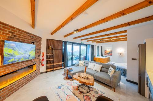 a living room with a couch and a brick wall at Grand Paradise Resort Sapanca in Sapanca