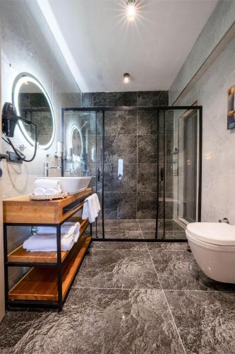 a bathroom with a shower and a sink and a toilet at Grand Paradise Resort Sapanca in Sapanca
