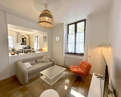 a living room with a couch and a chair at La Petite Saint-Paul in Granville