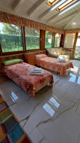 a large room with two beds and a couch at Villino Fatima in Crotone