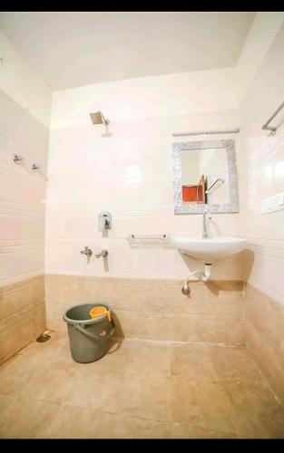 a bathroom with a sink and a toilet and a mirror at Aindra Coorg By Dazzle Destinations - Water Activities and Private Rooms in Subrahmanya