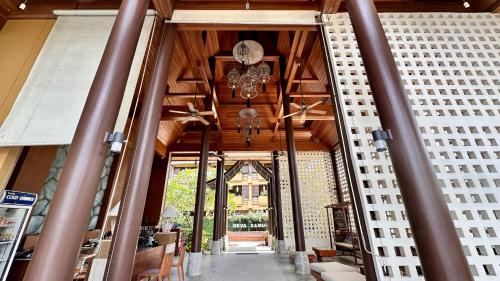 a hallway of a building with a clock on the ceiling at Deva Beach Resort Samui in Choeng Mon Beach