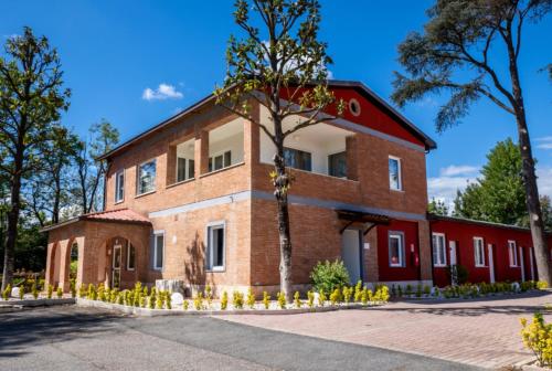 a brick building with a tree in front of it at Tiber Suite in Rome