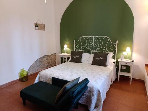 a bedroom with a bed with a green wall at Podere San Filippo B&B-Apartment-Pet Friendly-Rent Bike and Bike Friendly in Bibbona