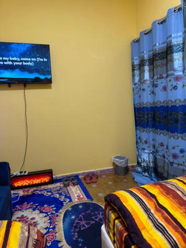a room with a bed and a chalkboard on the wall at MAMA DELiGHT HOME in Abu Dhabi