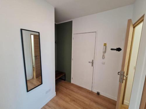 an empty room with a mirror and a door at Le ScottmanHouse - Appartement privé - Centre ville - Gare - Wi-Fi in Arras