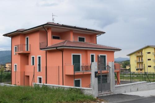 a orange building with a fence in front of it at Villa La Mulinella in Preturo