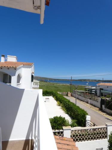 a view of the ocean from the balcony of a house at Hostal Port Fornells in Fornells