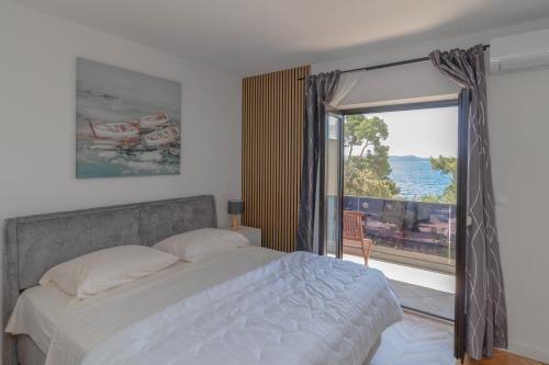 a bedroom with a bed and a large window at NEW! Apartment in Petrčane 30 meters from the sea - TA Leut Agency in Petrcane