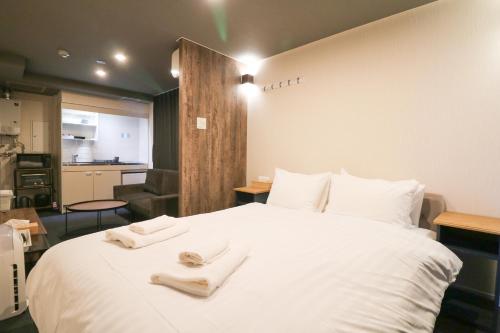 En eller flere senge i et værelse på Maison Odori Higashi Building