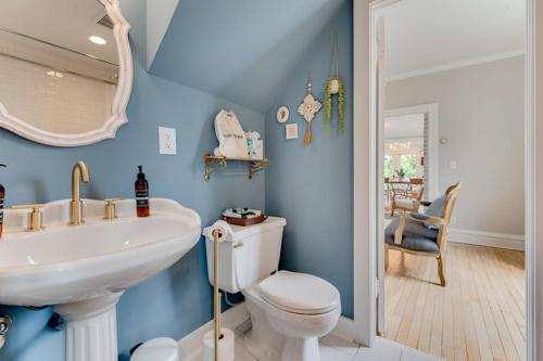 a blue bathroom with a sink and a toilet at The Estate House in Excelsior