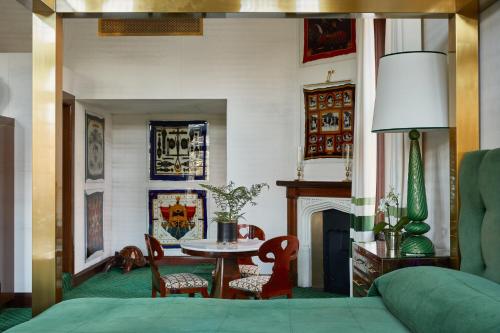 a living room with a bed and a table at Milestone Hotel Kensington in London