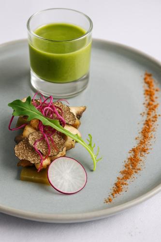 a plate of food with a glass of green juice at Le Goyen in Audierne