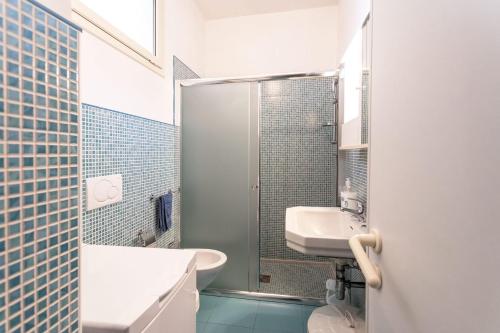 a bathroom with a shower and a sink and a toilet at Villetta Giovanna a 50m dal mare - Salento Reservation in Marina di Mancaversa