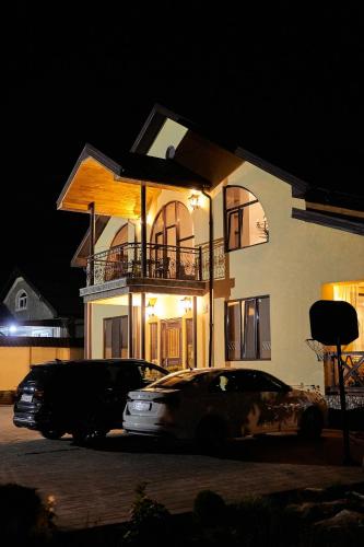 a car parked in front of a house at night at Villa Vermont Qusar in Qusar