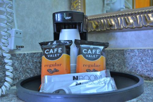 a pile of toiletries sitting on a bathroom counter at Deluxe Inn - Fayetteville I-95 in Fayetteville
