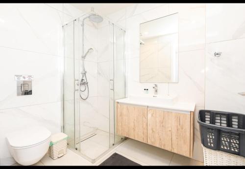 a bathroom with a shower and a toilet and a sink at Protaras The Icon 001 at Mythical Seas in Paralimni