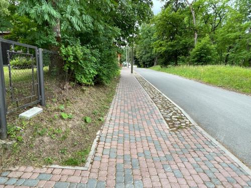 a brick sidewalk on the side of a road at Kunderi apartment with sauna in Rakvere