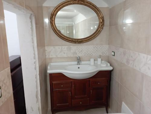 a bathroom with a sink and a mirror at B&B Sara in Tuglie