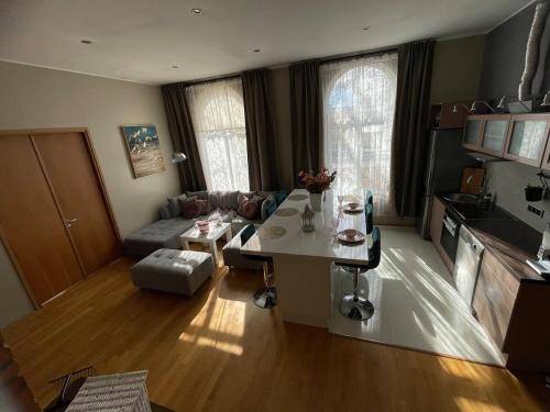a living room with a table and a couch at Kunderi apartment with sauna in Rakvere