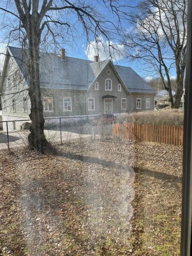 a large house with a fence in front of it at Kunderi apartment with sauna in Rakvere