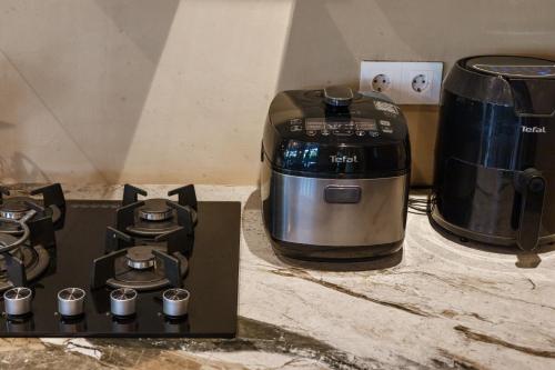 a coffee maker and a toaster on a counter at Luxurious Arakana Villa with Pool in Jimbaran