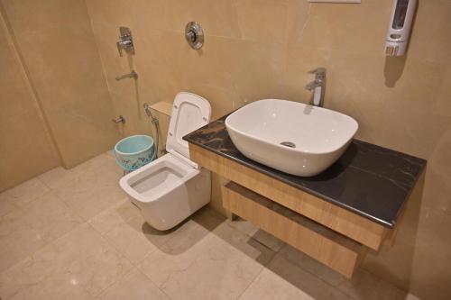 a bathroom with a sink and a toilet at Nirvana Bliss Prayagraj in Prayagraj