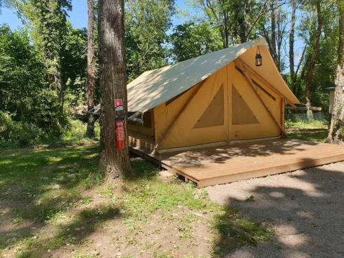 a yellow tent sitting next to a tree at Camping 3 étoiles - ccaiaah in Monoblet