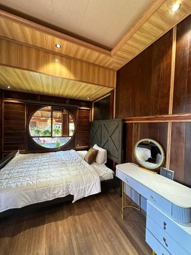 a bedroom with a bed and a desk in a boat at Riverside in Hòa Bình