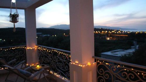 a balcony with a view of a city at night at Constantin in Dhémbla