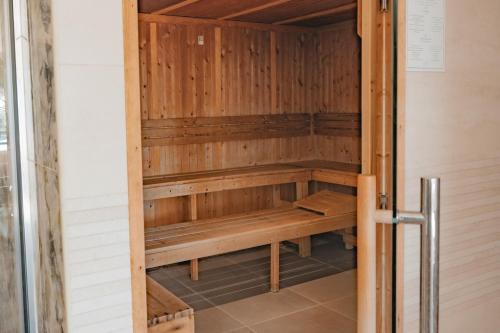 a sauna with wooden benches in a room at Hôtel Édenia - Spa Estime&Sens in Carnac