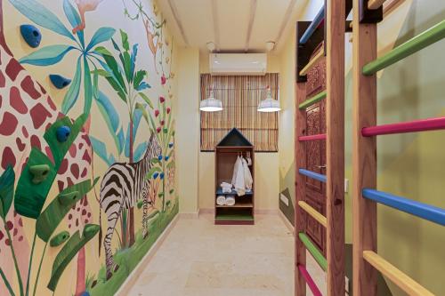 a hallway with a giraffe mural on the wall at Luxurious Arakana Villa with Pool in Jimbaran
