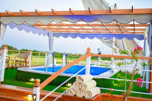 a hot tub in a tent with towels on a table at دهبيه كوين شارلوت in Luxor