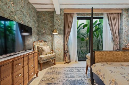 a bedroom with a bed and a dresser and a window at Luxurious Arakana Villa with Pool in Jimbaran