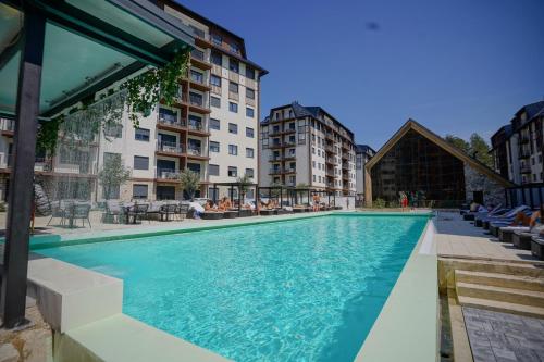 a swimming pool in the middle of a building at Titova Vila Zlatibor Mountain View Apartment in Zlatibor