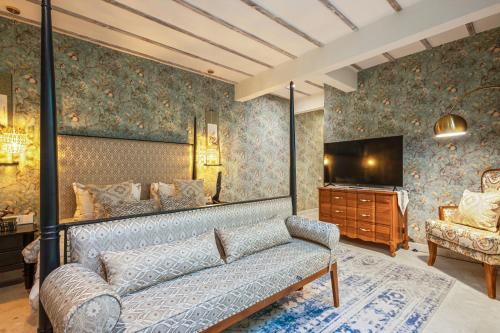 a living room with a couch and a television at Luxurious Arakana Villa with Pool in Jimbaran
